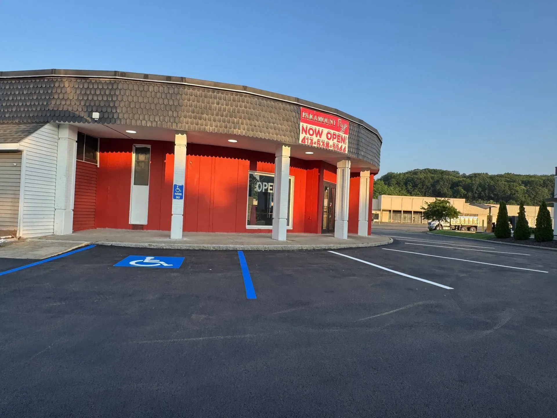 Exterior of a red and white building with a sign reading 