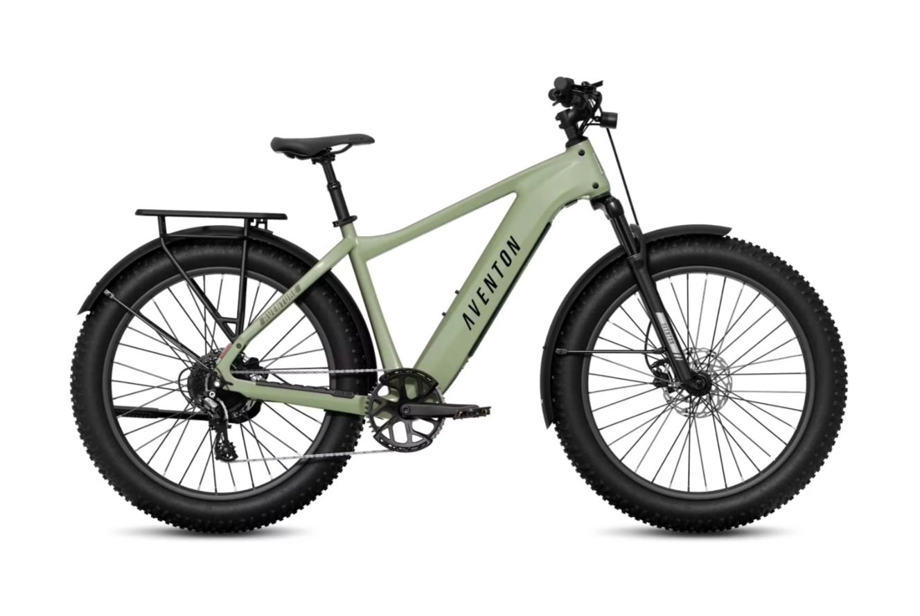 Light green electric cargo bike with black fat tires and rear rack on a white background