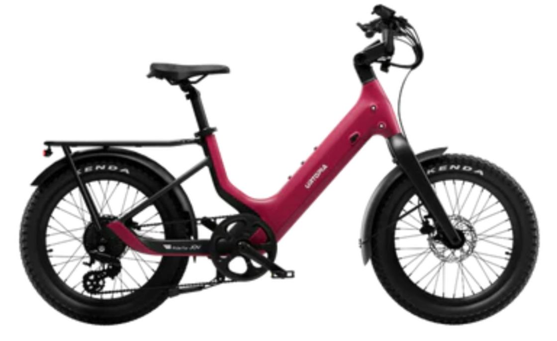 Pink electric cargo bike with fat tires and rear rack on a white background