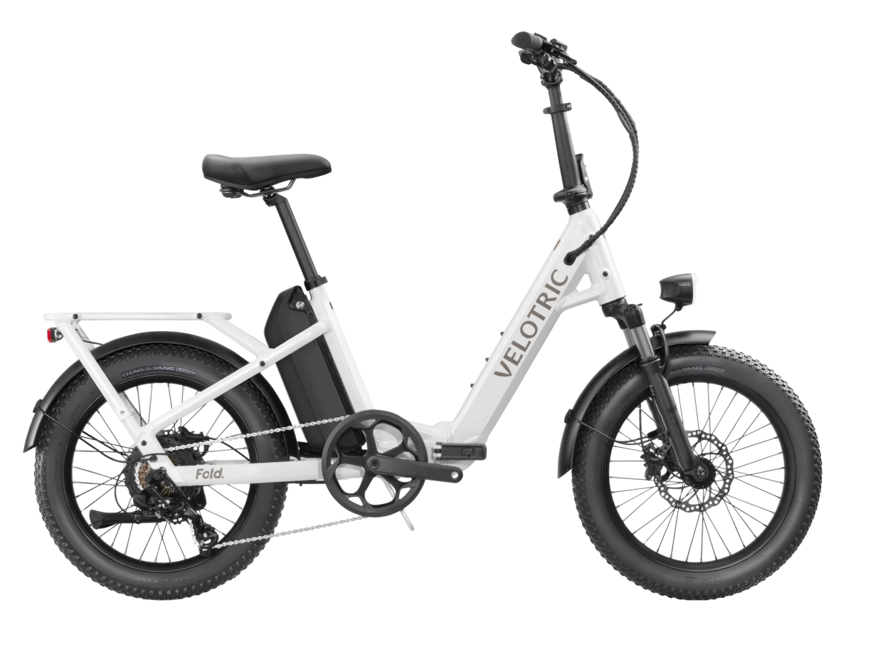 White folding electric bike with black tires and seat, shown in side view on a plain background
