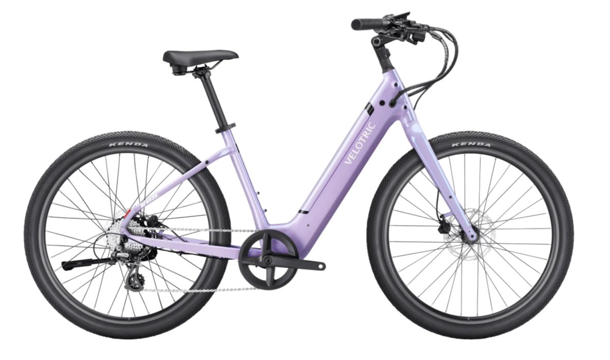 Lavender step-through electric bicycle with black wheels and handlebars on a white background