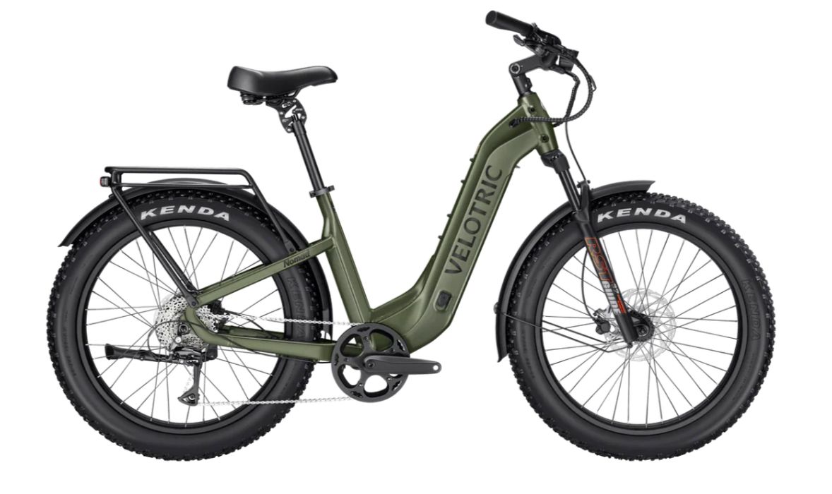 Olive green electric fat-tire bike with rear rack and front suspension on white background