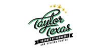 Taylor Texas logo with green script, stars, and black ribbon text on a white background