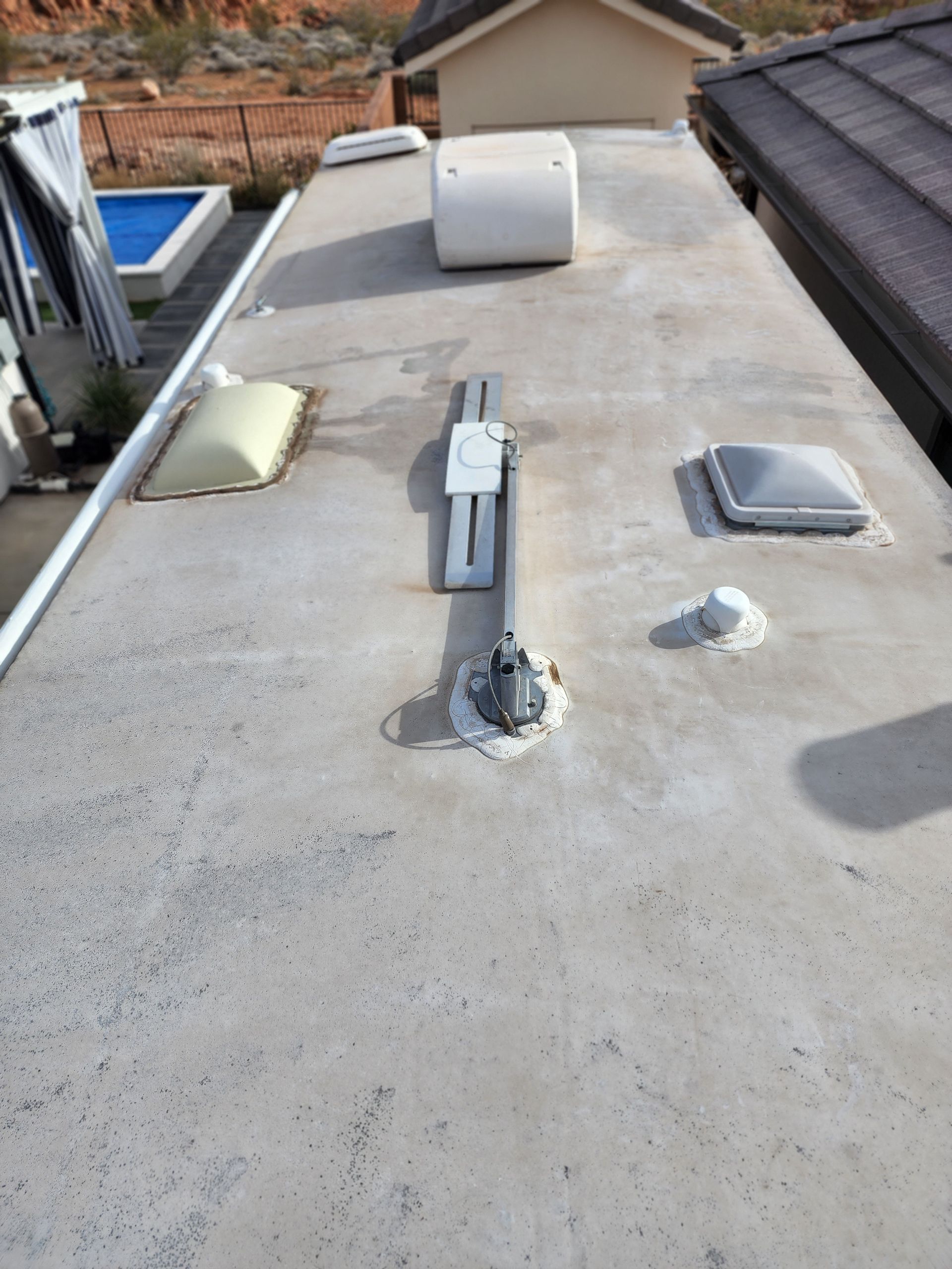 RV roof with vents and a satellite dish.