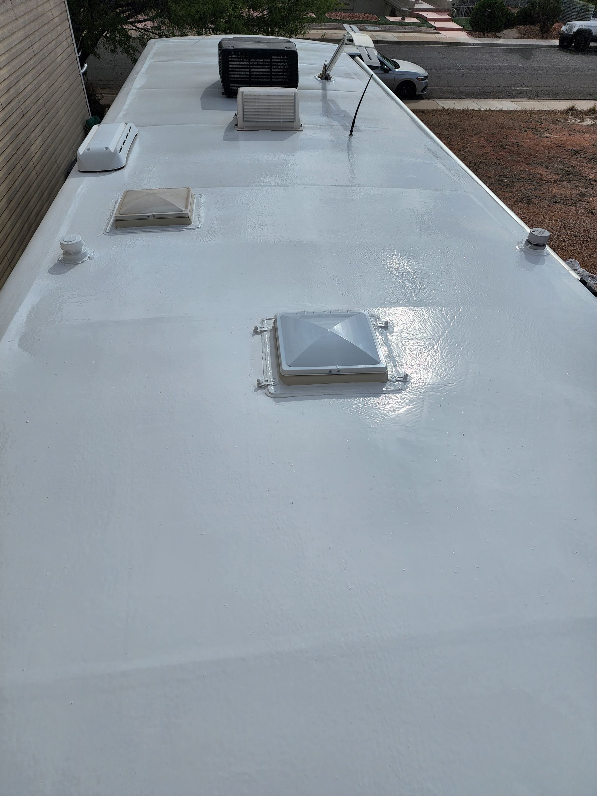 White RV roof with vents and fixtures.