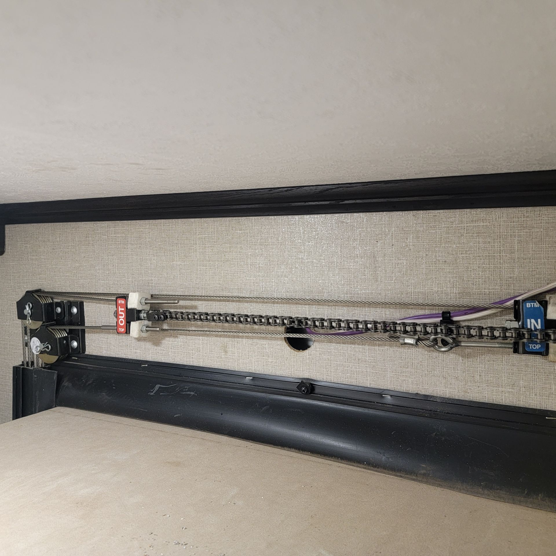 RV awning mechanism with chain and gears.