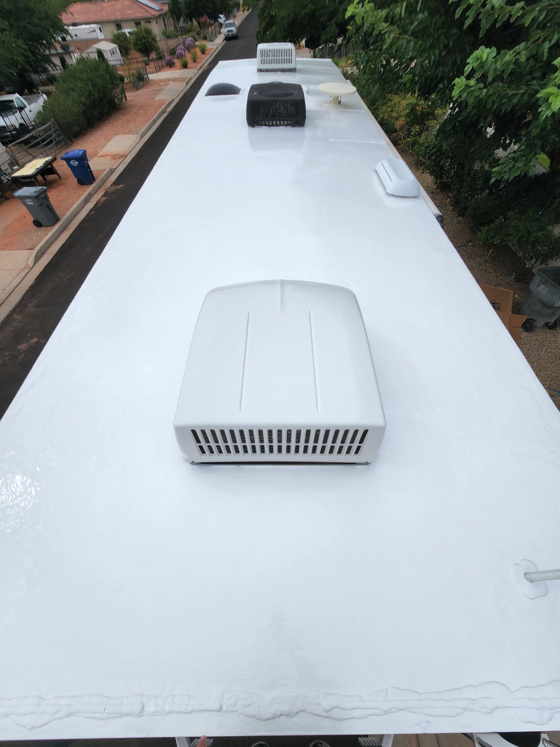 White RV roof with air conditioning units and vents.