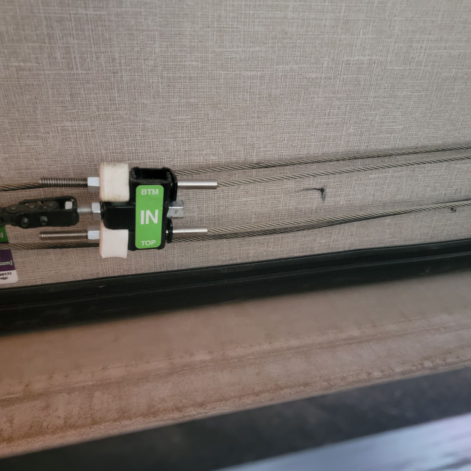 Close-up of a window blind cord mechanism, showing the 