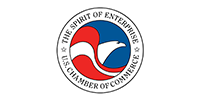 Circular Chamber of Commerce logo with red, white, and blue sail-like emblem and surrounding text