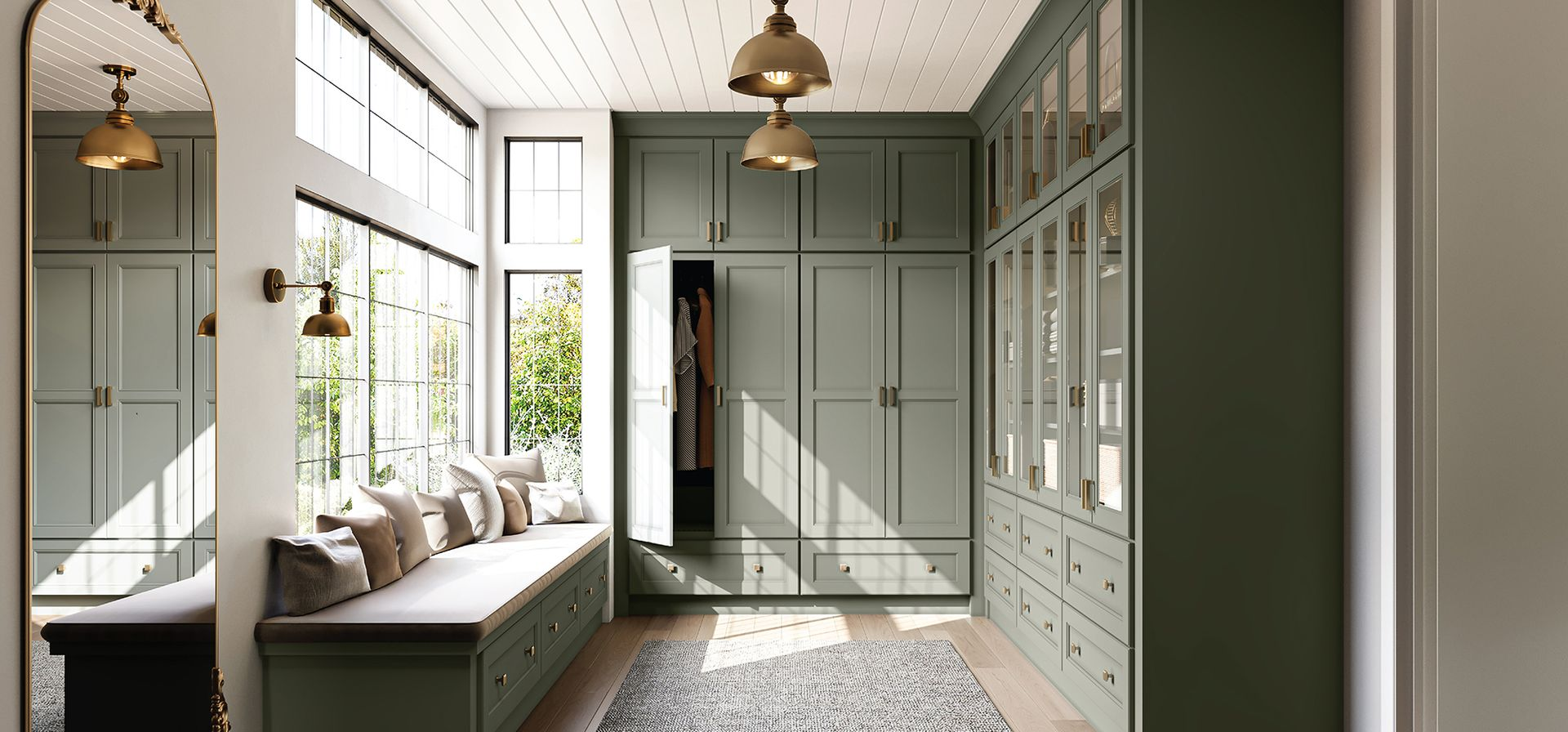 Green-painted walk-in closet with window seat, Fabuwood light green cabinets, hardwood floors, Closet Design by Westchester Design Center, Larchmont, NY
