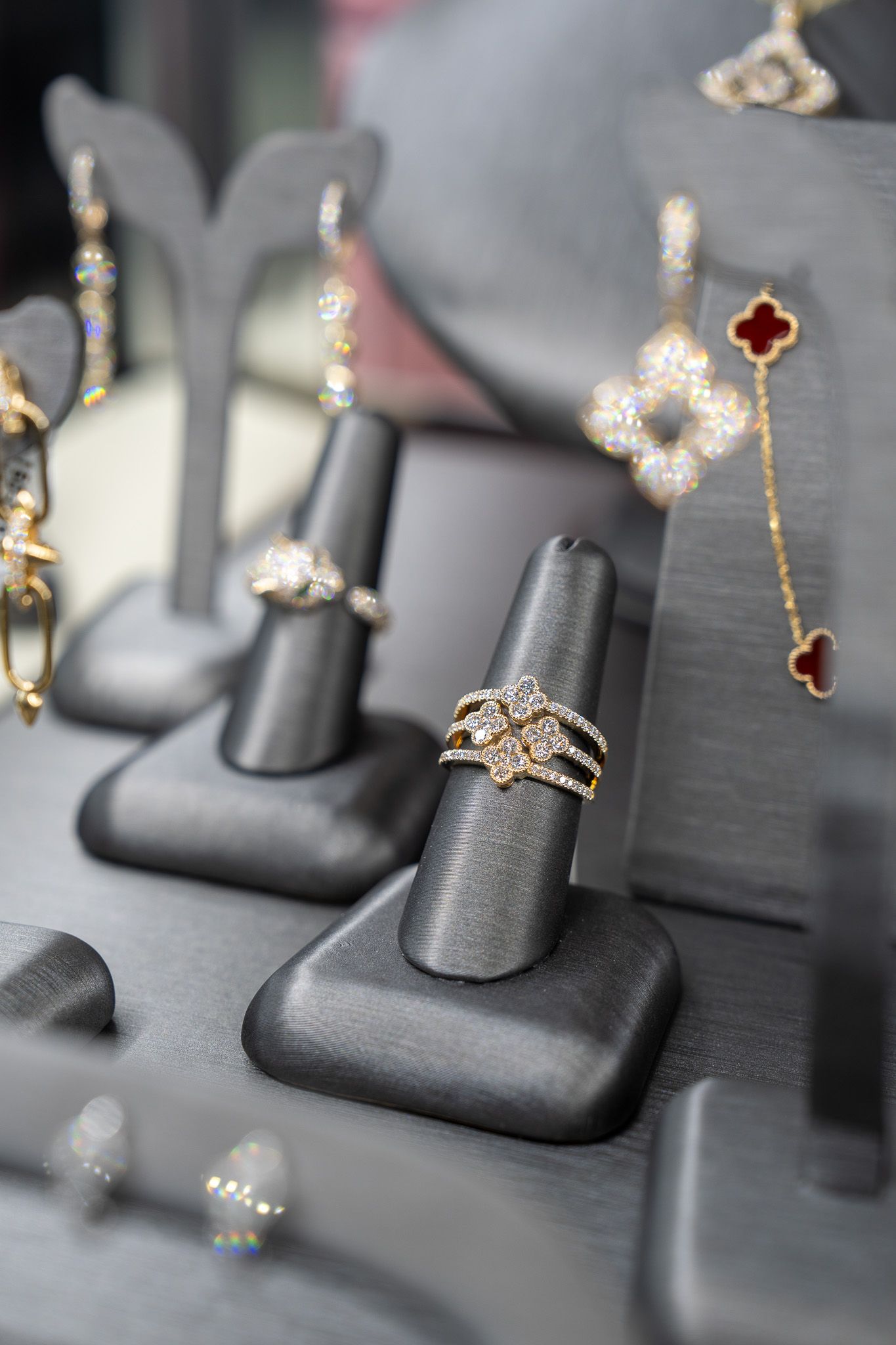 Gold rings on black display stands in a jewelry case
