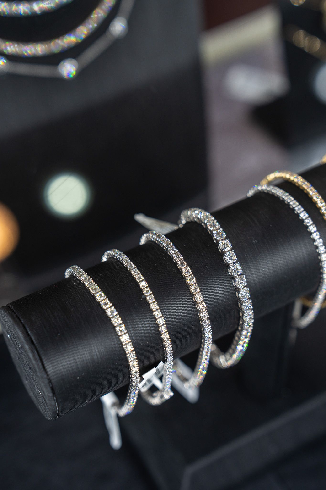 Silver bracelets on a black display stand in a jewelry shop