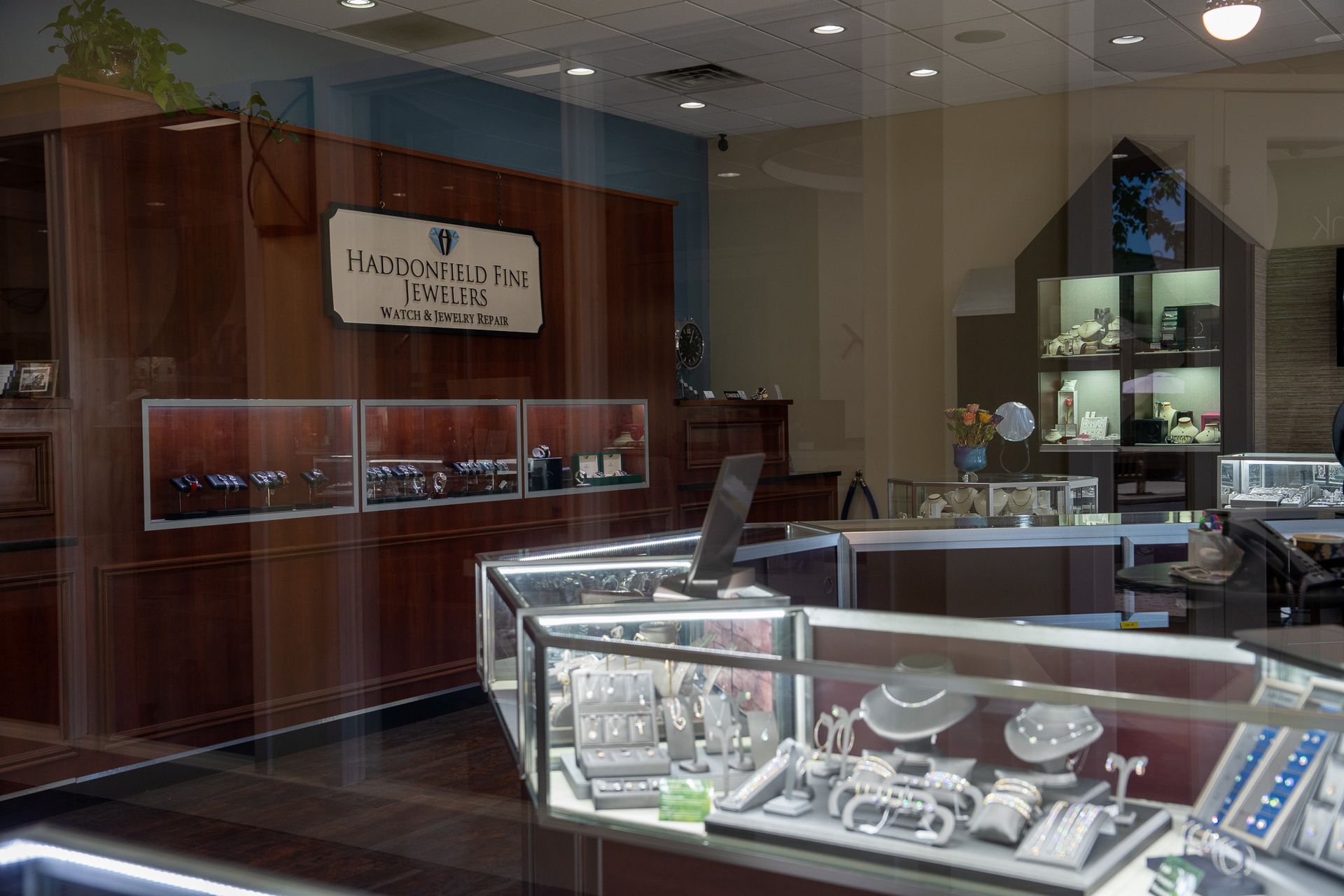Jewelry store interior with glass display cases and wood-paneled walls