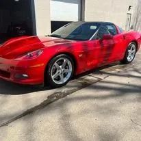 Red Chevrolet Corvette parked outside.