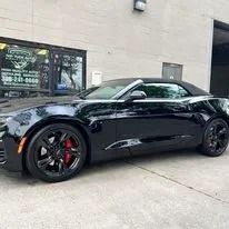 Black convertible car parked outside a building.