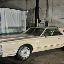 Tan Lincoln Continental in a garage.