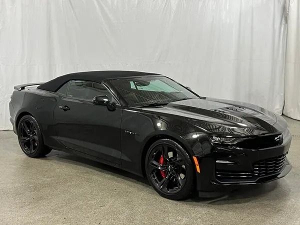 Black Chevrolet Camaro convertible with red brake calipers.