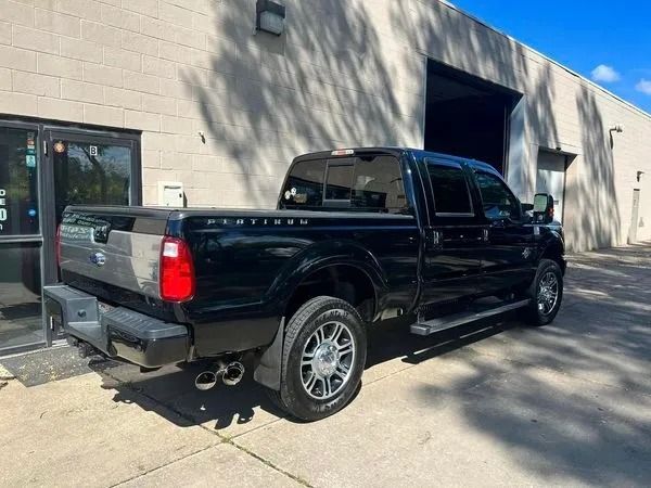 Black Ford F-350 Platinum truck parked outside a building. Shiny chrome wheels and exhaust tips.