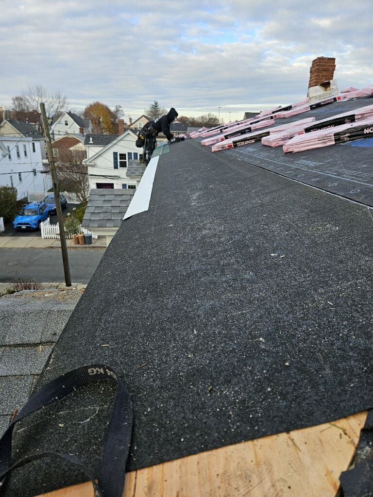 A person is standing on top of a roof.