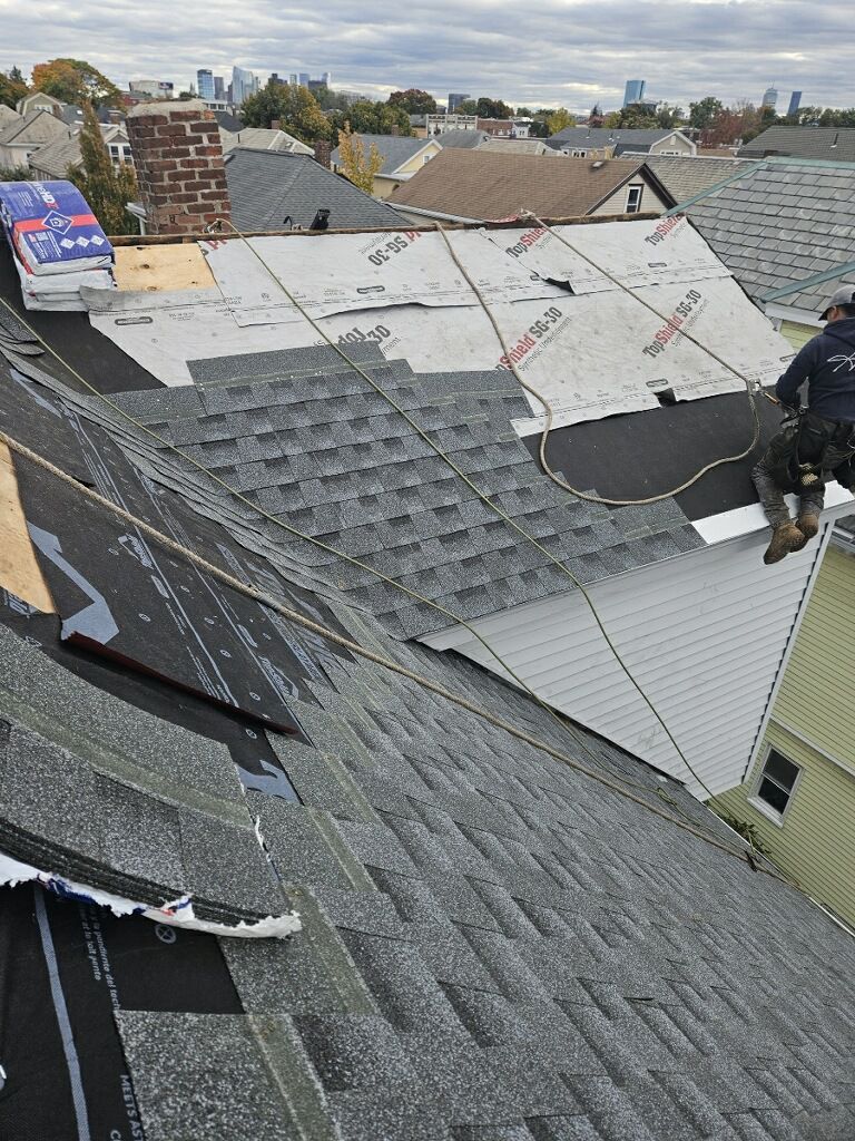 A man is working on the roof of a house.