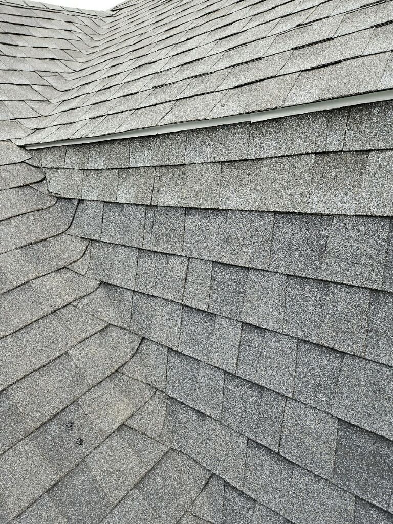 A close up of a roof with a lot of shingles on it.