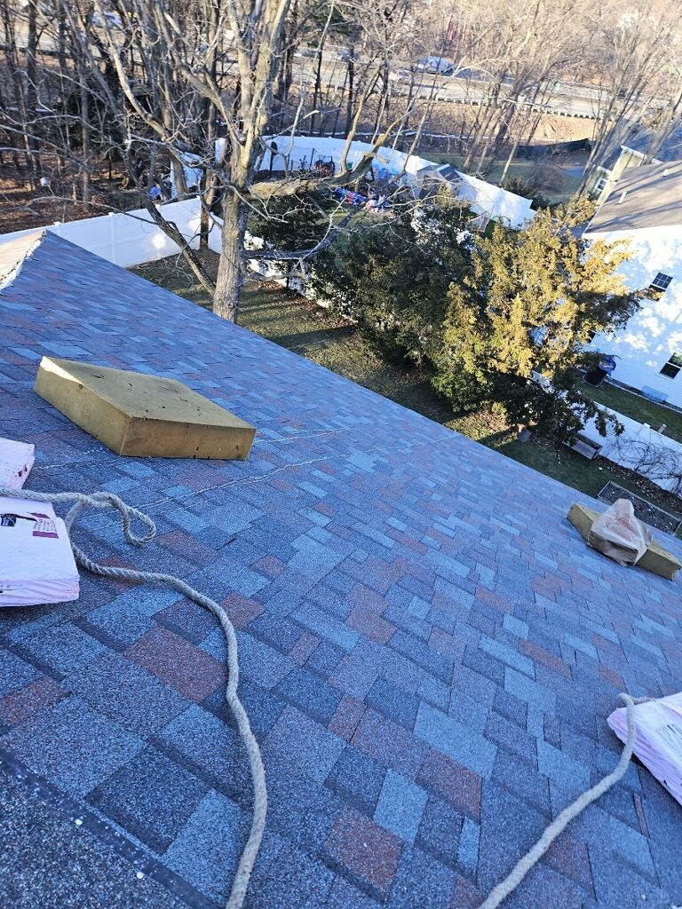 A roof with a lot of shingles on it is being repaired.