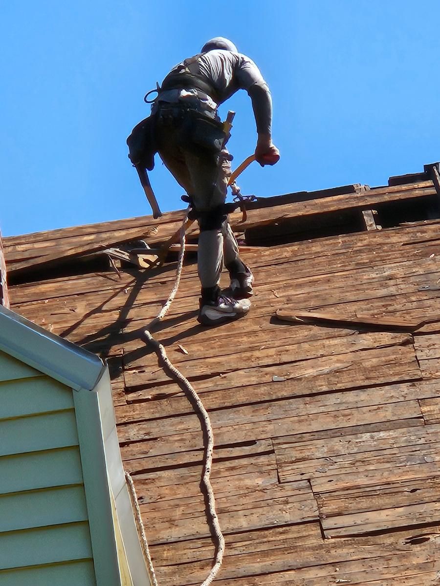 A man is working on the roof of a house