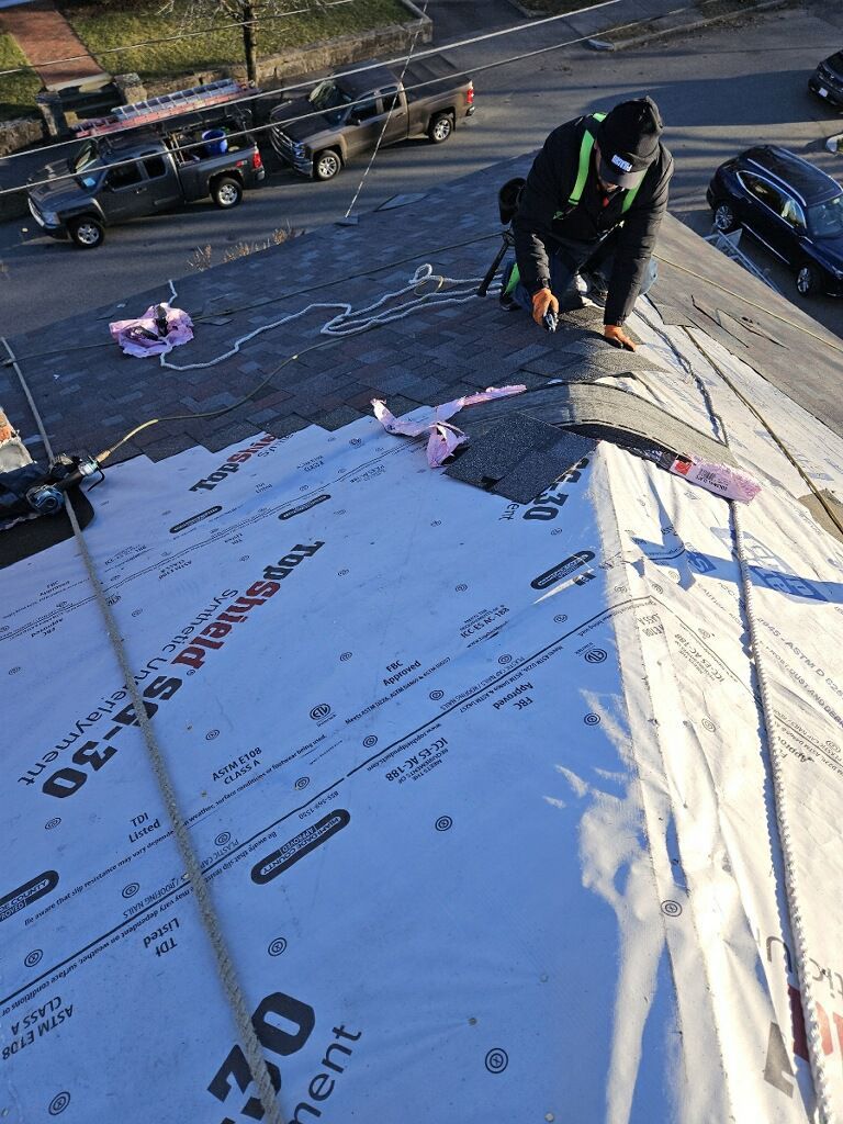A man is working on the roof of a building.