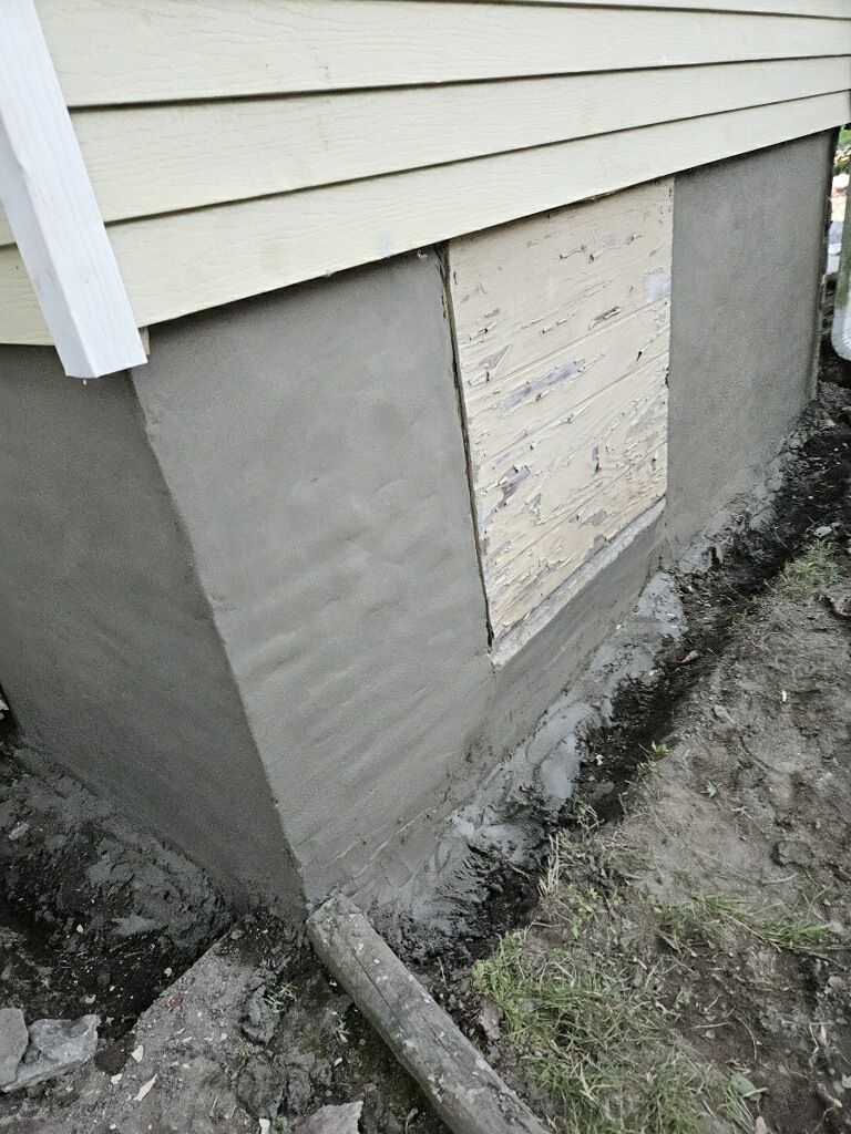 A house with a window that has been boarded up.