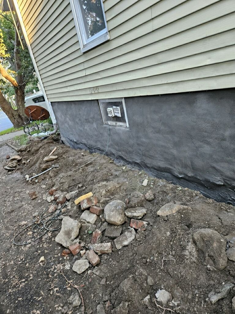 A house with a lot of rocks and dirt in front of it.