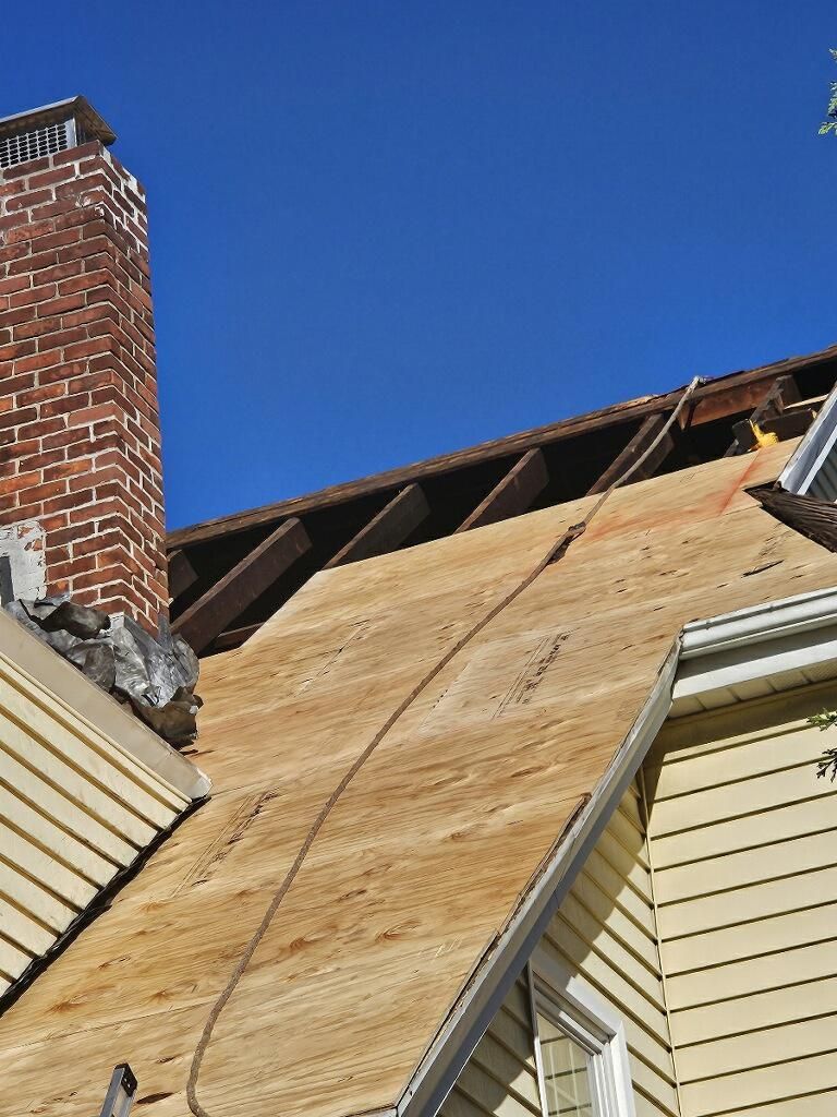A roof with a chimney and a ladder on it