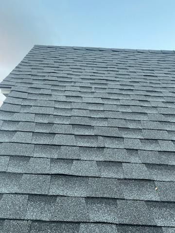 A close up of a roof with a blue sky in the background.