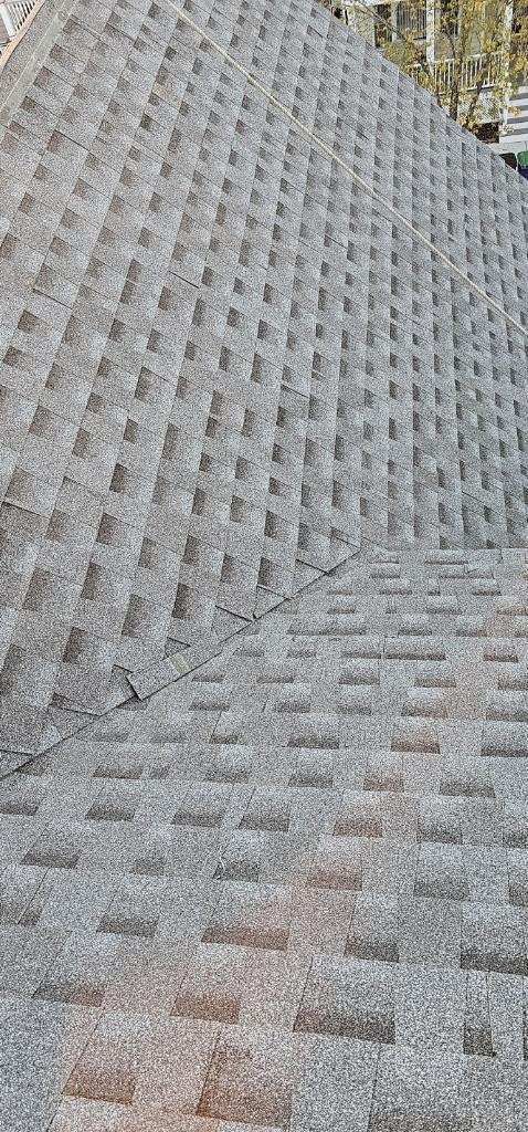 A close up of a roof with a lot of shingles on it.