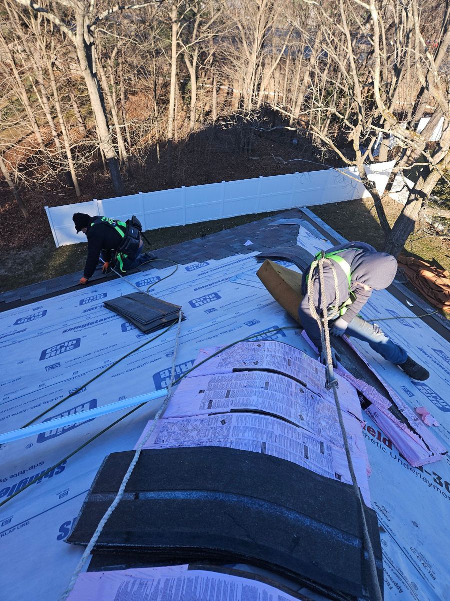 A group of people are working on a roof.