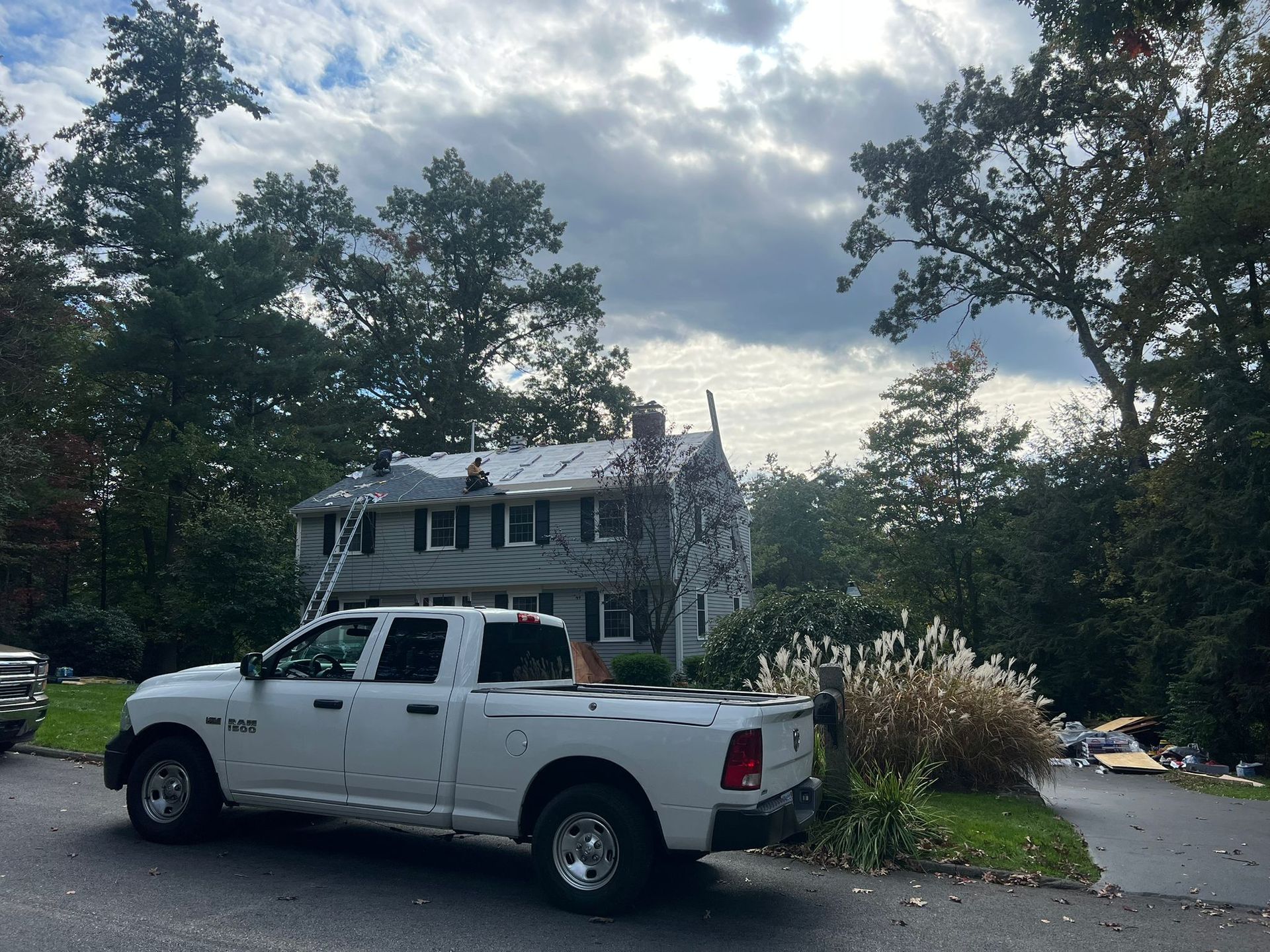 A white truck is parked in front of a house.