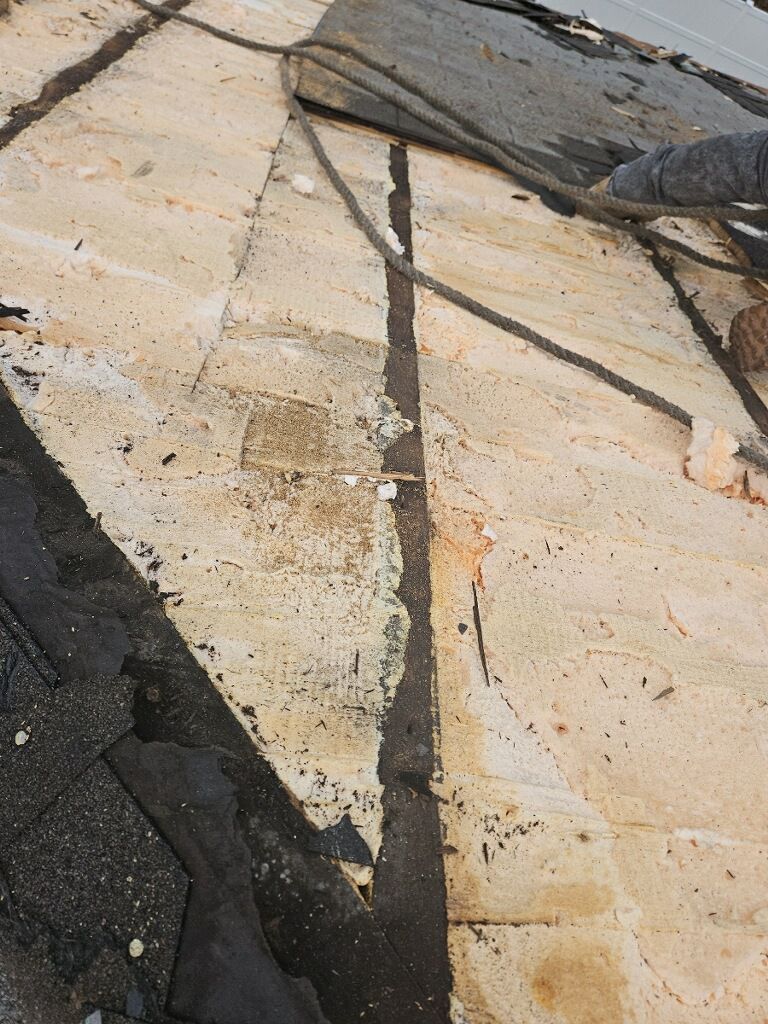 A close up of a roof with a few pieces of shingles on it.