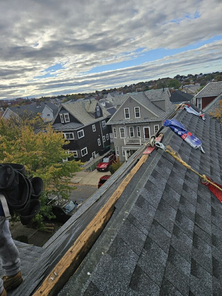 A man is working on the roof of a house.