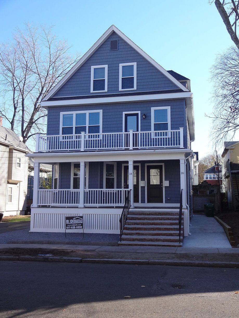 Blue two-story house with white porches, stairs, and a ramp leading to the front door.