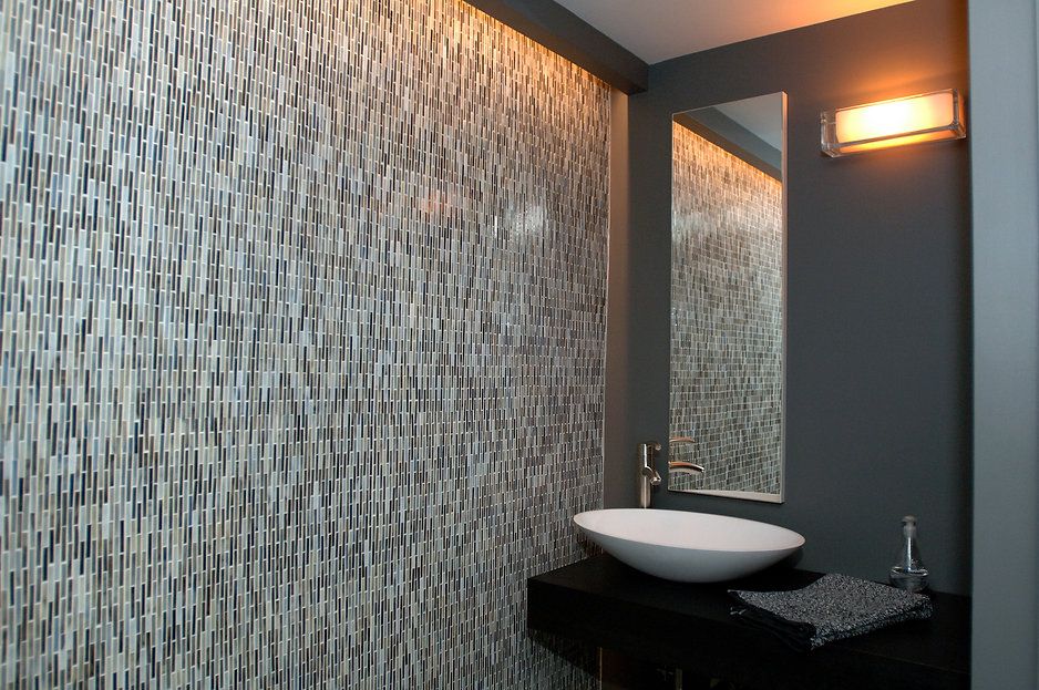 Small bathroom with mosaic tile wall, white vessel sink, and dark gray walls.
