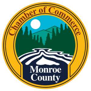 Monroe County Chamber of Commerce logo: river, mountains, trees, blue sky, and a sun. Text: 