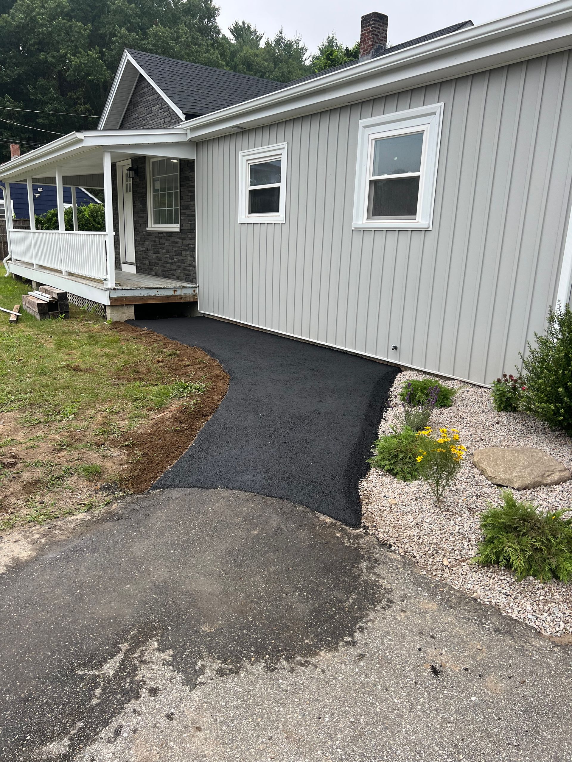 A house with a walkway leading to the front door.