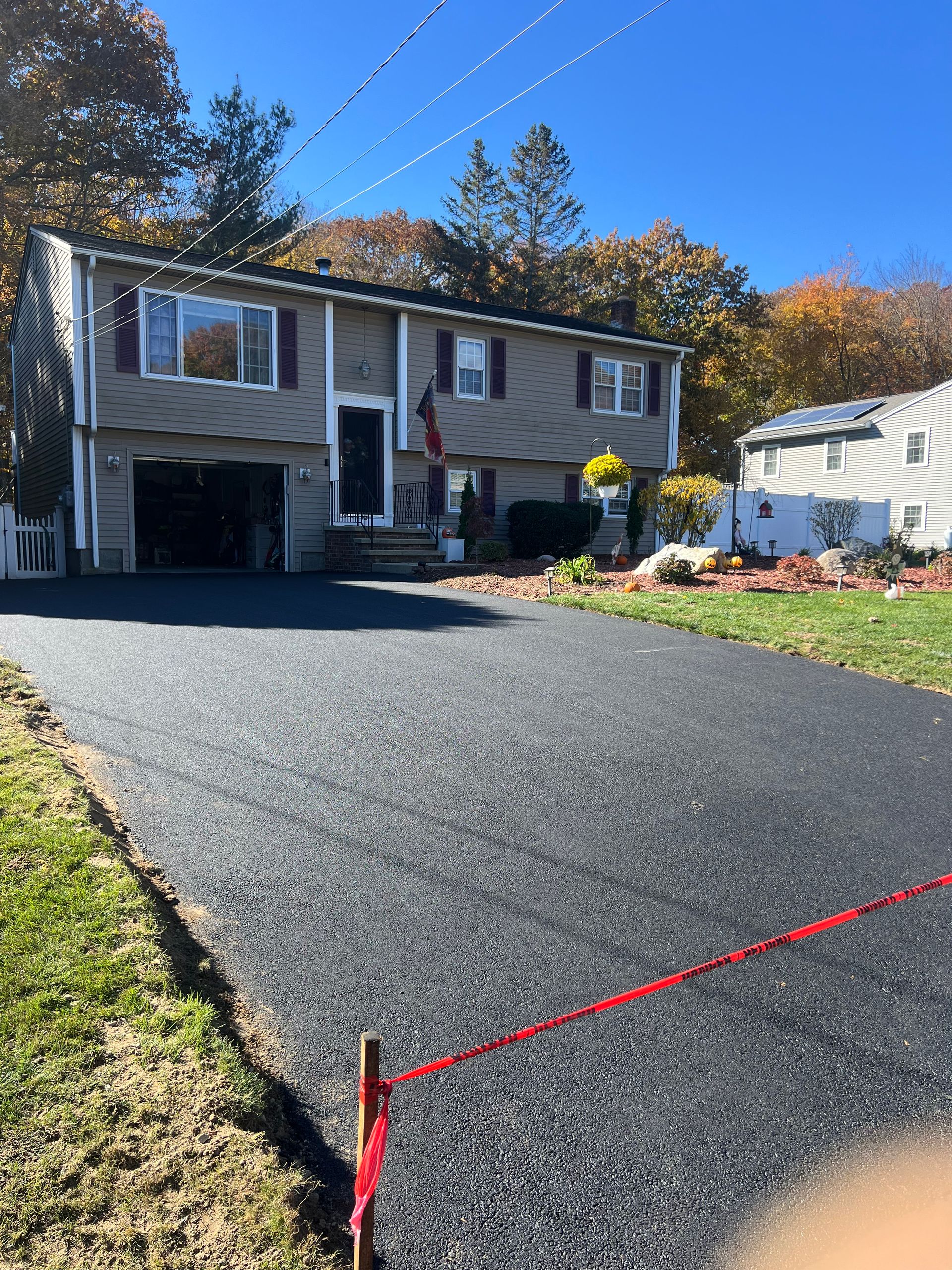 A house with a large driveway in front of it.