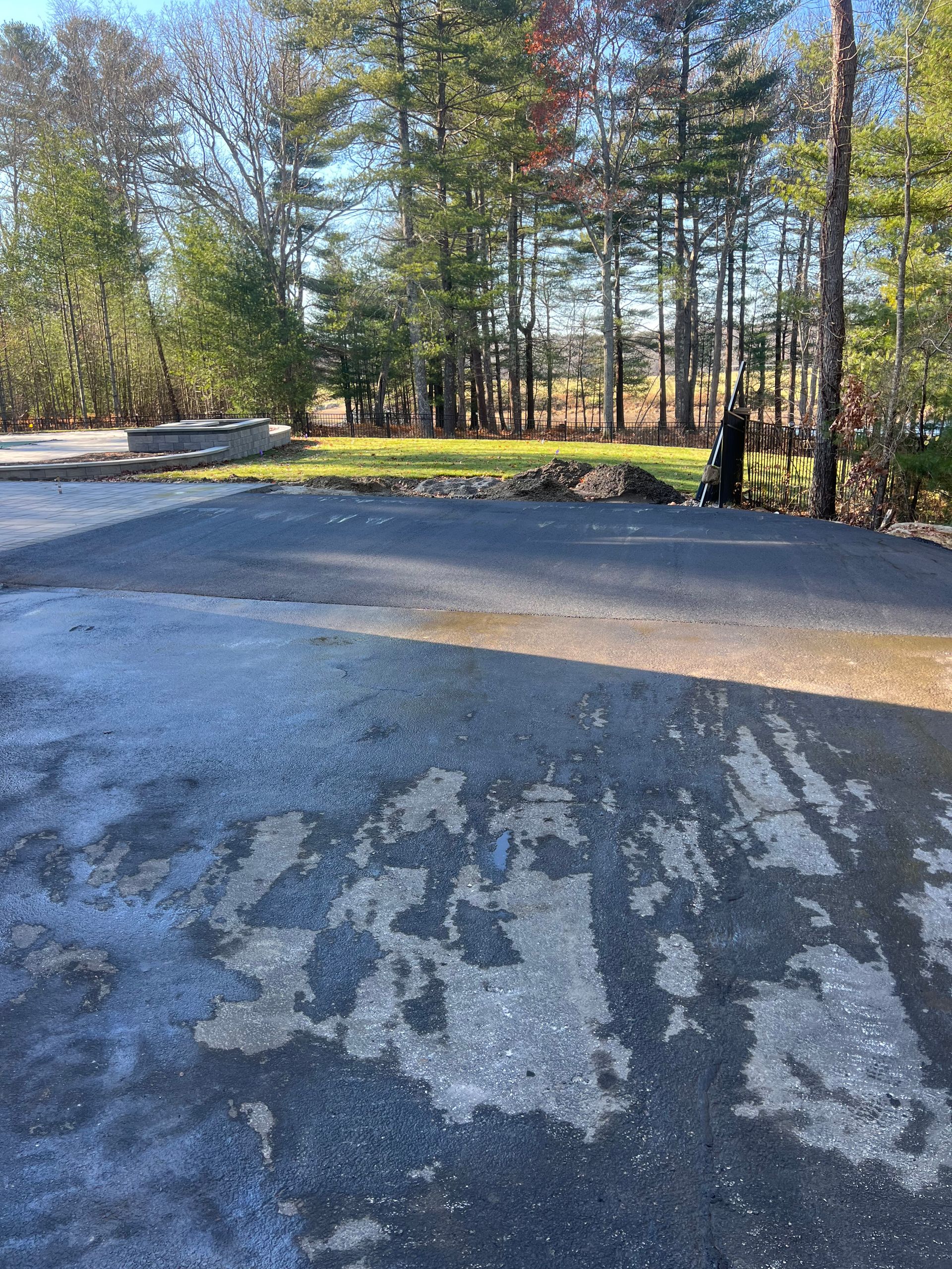 A parking lot with a lot of trees in the background.