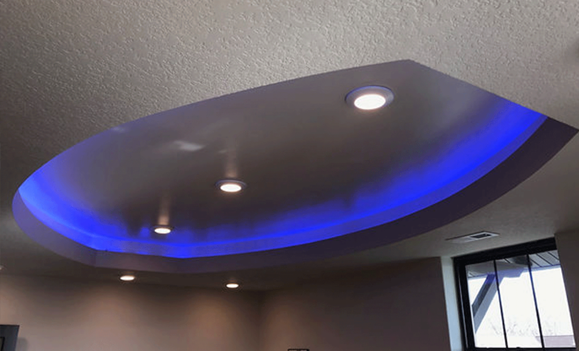 a room with a ceiling that has blue lights on it .