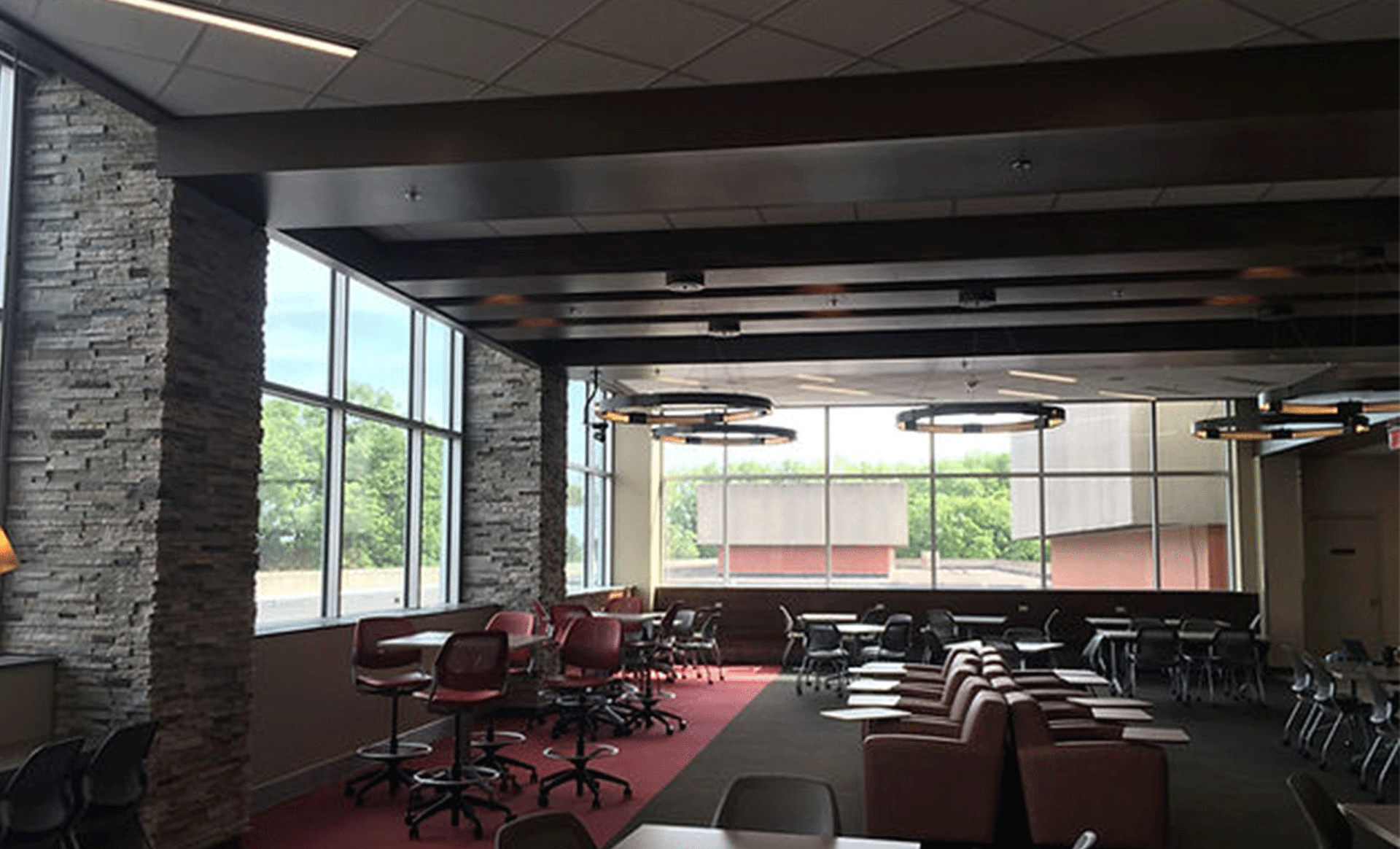a large room with tables and chairs and lots of windows