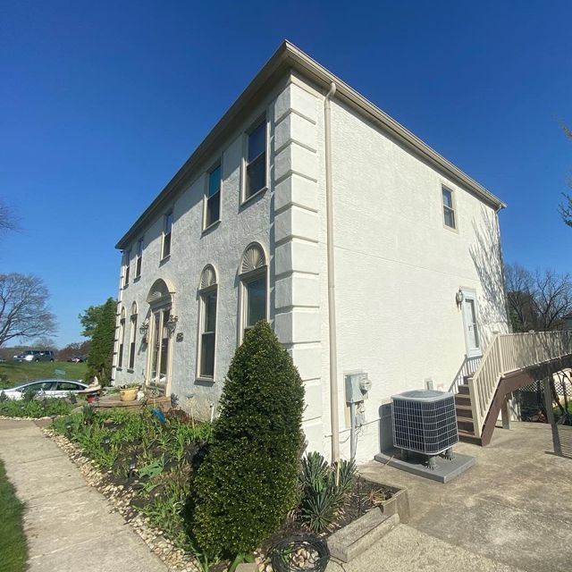 A large white building with stairs leading up to it