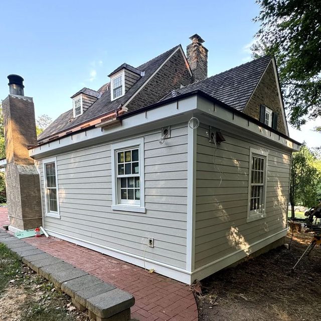 A white house with a brick chimney on the roof