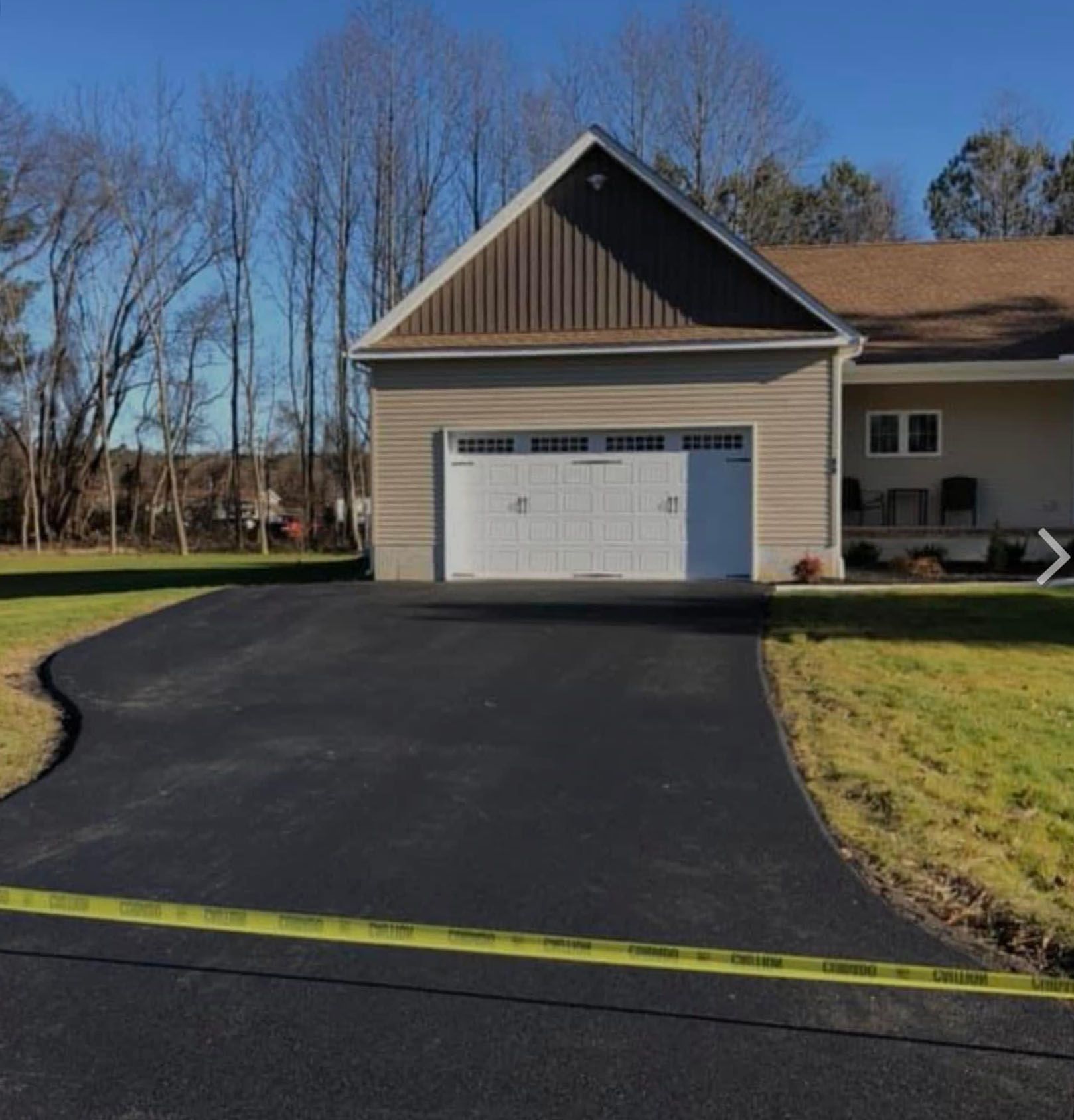 A driveway leading to a house with a garage