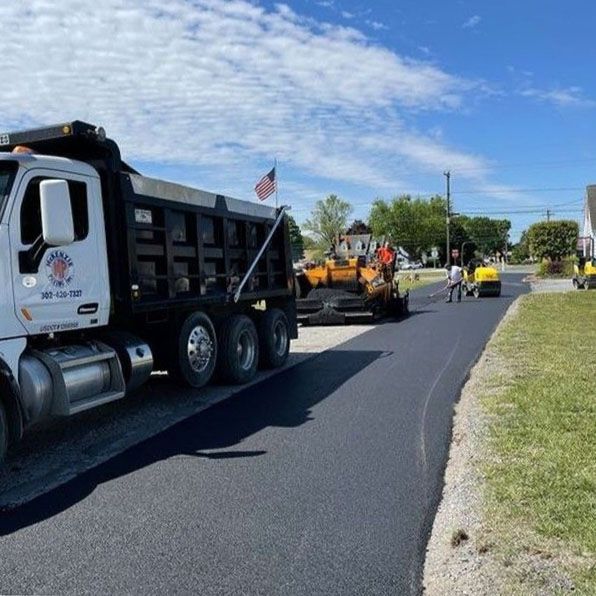 A dump truck is parked on the side of the road