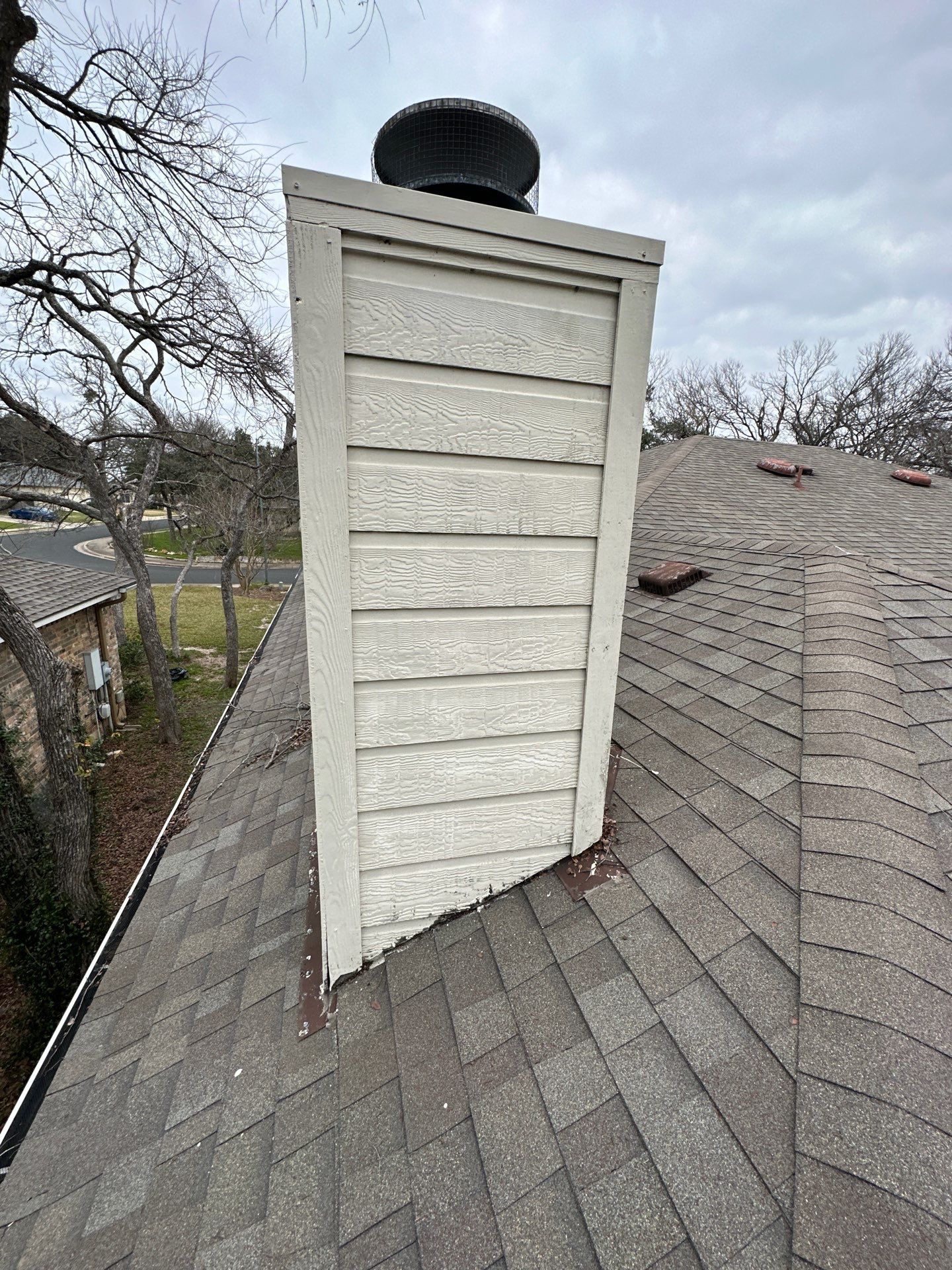 A chimney is sitting on top of a roof - before